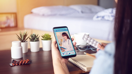 woman using healthcare app on her cell phone